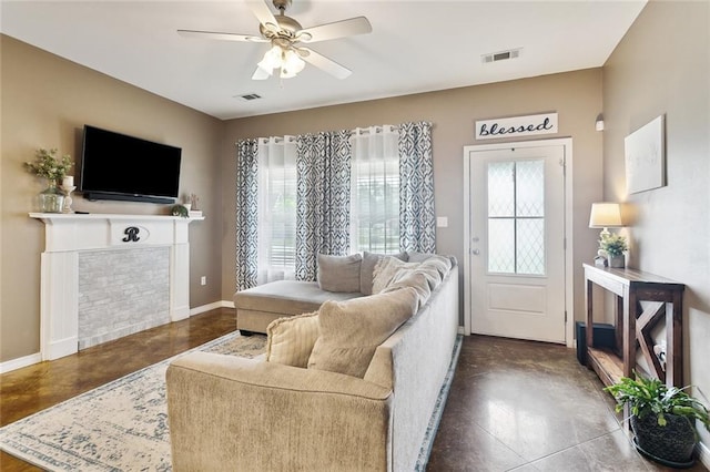 258 S Park Cir, Ponchatoula, LA 70454 - living area featuring baseboards, a ceiling fan, finished concrete floors, and a tiled fireplace