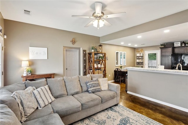 258 S Park Cir, Ponchatoula, LA 70454 - living room with finished concrete floors, a ceiling fan, recessed lighting, and baseboards