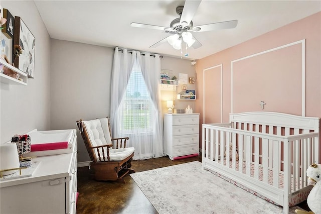 258 S Park Cir, Ponchatoula, LA 70454 - bedroom featuring finished concrete floors, a crib, and ceiling fan