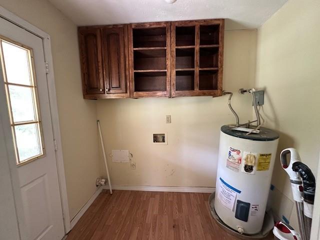 44373 Elmer Magee Rd, Franklinton, LA 70438 - laundry room featuring cabinet space, electric water heater, wood finished floors, hookup for a washing machine, and plenty of natural light