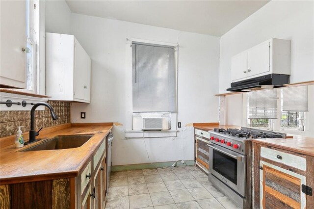 2239 General Taylor St, New Orleans, LA 70115 - kitchen with under cabinet range hood, stainless steel appliances, white cabinets, decorative backsplash, and cooling unit