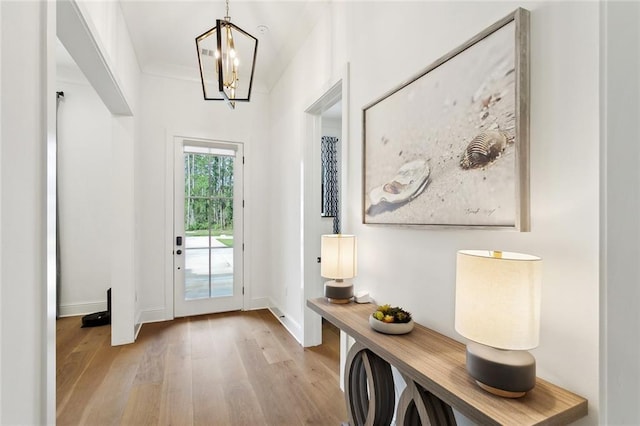 121 Chateau Papillon Ln, Mandeville, LA 70471 - entryway with light wood-style floors, a chandelier, and baseboards