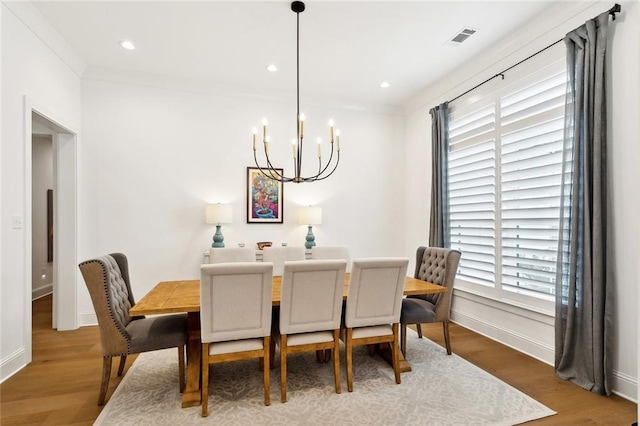 121 Chateau Papillon Ln, Mandeville, LA 70471 - dining room featuring a chandelier, baseboards, wood finished floors, recessed lighting, and crown molding