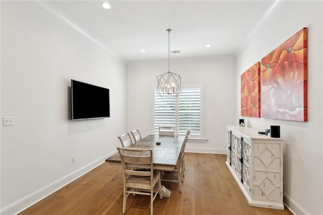 121 Chateau Papillon Ln, Mandeville, LA 70471 - dining area featuring a chandelier, light wood-style flooring, baseboards, recessed lighting, and crown molding