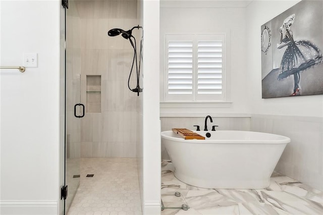 121 Chateau Papillon Ln, Mandeville, LA 70471 - bathroom featuring a stall shower, a freestanding bath, marble finish flooring, and wainscoting