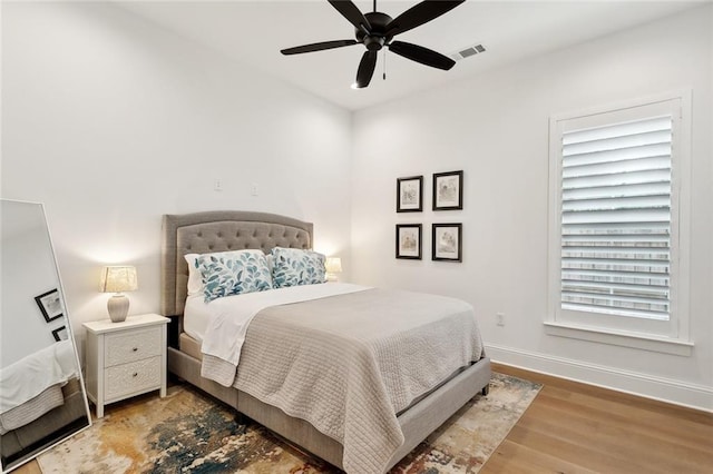 121 Chateau Papillon Ln, Mandeville, LA 70471 - bedroom with wood finished floors, baseboards, and ceiling fan