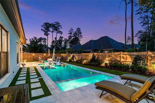 121 Chateau Papillon Ln, Mandeville, LA 70471 - pool at dusk featuring a patio, a fenced backyard, and a pool with connected hot tub