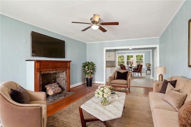 4435 Baccich St, New Orleans, LA 70122 - living room featuring wood finished floors, a ceiling fan, ornamental molding, and a high end fireplace