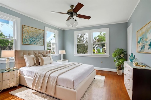 4435 Baccich St, New Orleans, LA 70122 - bedroom with multiple windows, wood finished floors, ornamental molding, baseboards, and ceiling fan