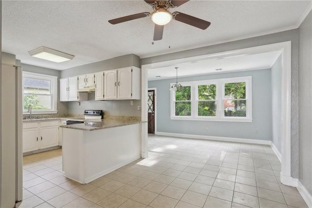4435 Baccich St, New Orleans, LA 70122 - kitchen with range with electric stovetop, under cabinet range hood, healthy amount of natural light, a textured ceiling, and white cabinetry