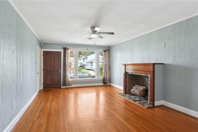 4435 Baccich St, New Orleans, LA 70122 - unfurnished living room with wood finished floors, ceiling fan, a fireplace with flush hearth, crown molding, and baseboards