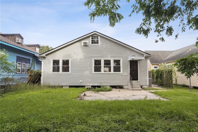 4435 Baccich St, New Orleans, LA 70122 - back of property with entry steps, a patio, and a yard