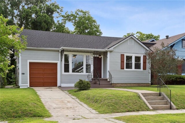 4435 Baccich St, New Orleans, LA 70122 - ranch-style home with a garage, driveway, a front yard, and roof with shingles