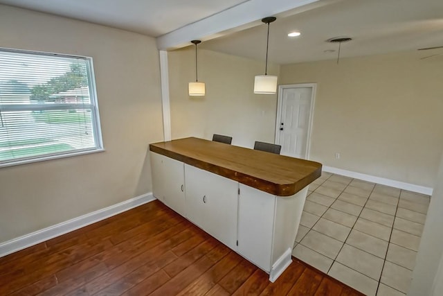 3617 Tartan Dr, Metairie, LA 70003 - kitchen featuring a peninsula, pendant lighting, dark wood-style floors, butcher block counters, and recessed lighting