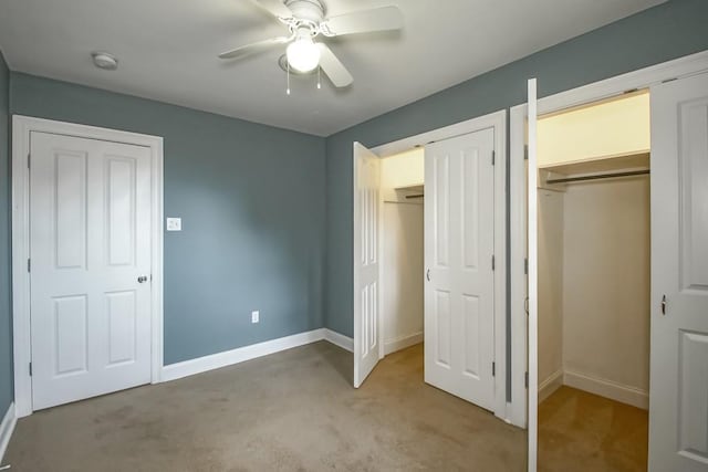 3617 Tartan Dr, Metairie, LA 70003 - unfurnished bedroom with light carpet, two closets, and ceiling fan