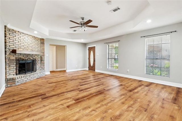 2716 Mayflower St, Meraux, LA 70075 - unfurnished living room with a tray ceiling, wood finished floors, a ceiling fan, recessed lighting, and baseboards