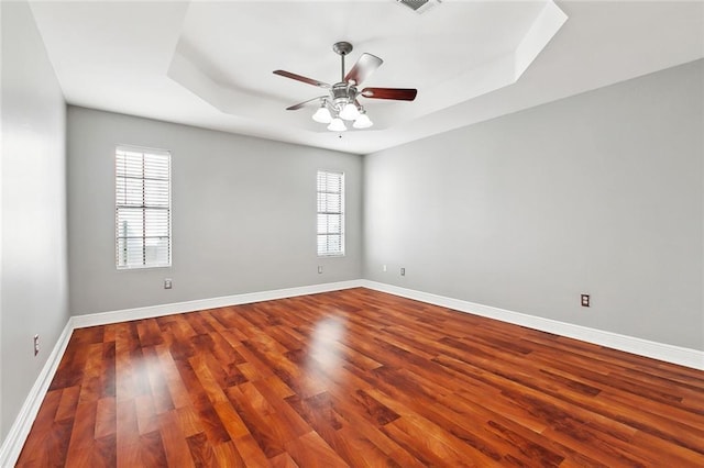 2716 Mayflower St, Meraux, LA 70075 - spare room with plenty of natural light, wood finished floors, a tray ceiling, and a ceiling fan