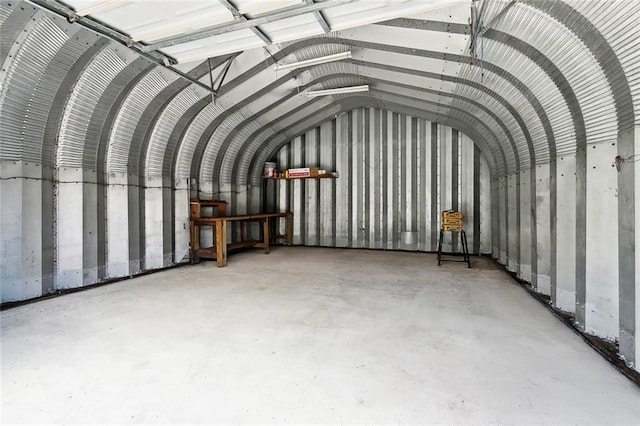 2716 Mayflower St, Meraux, LA 70075 - miscellaneous room with lofted ceiling, concrete flooring, and a garage