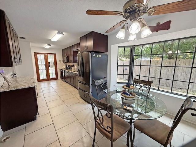 8809 Belle Grove Pl, River Ridge, LA 70123 - dining area featuring ceiling fan, light tile patterned flooring, and a textured ceiling