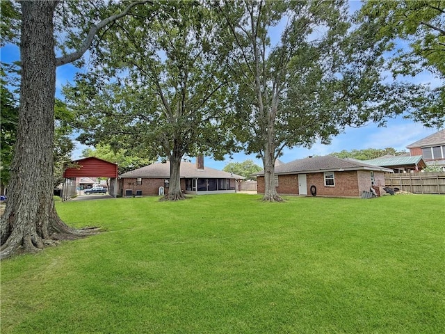8809 Belle Grove Pl, River Ridge, LA 70123 - view of yard with a carport and a sunroom