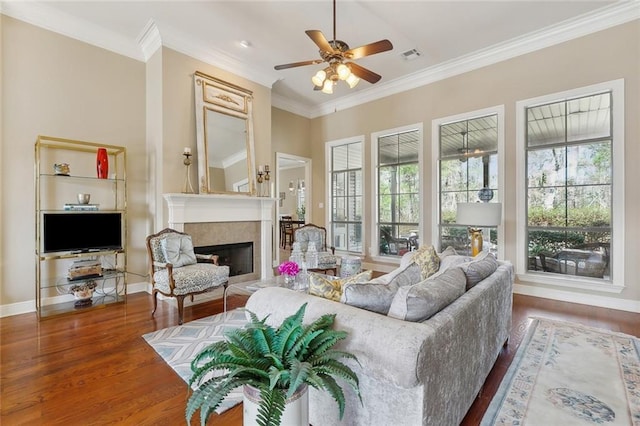 404 Southdown Loop, Covington, LA 70433 - living area featuring wood finished floors, ornamental molding, a ceiling fan, a fireplace, and baseboards