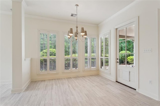 404 Southdown Loop, Covington, LA 70433 - unfurnished dining area featuring a chandelier, ornamental molding, baseboards, and light wood finished floors
