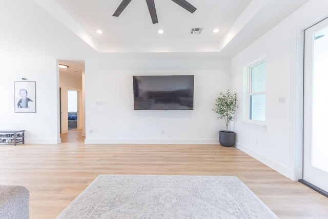 322 Spartan Loop, Slidell, LA 70458 - unfurnished living room with ceiling fan, light wood-style flooring, a tray ceiling, baseboards, and recessed lighting