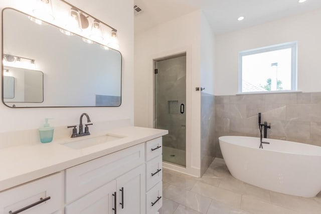 322 Spartan Loop, Slidell, LA 70458 - bathroom featuring vanity, a shower stall, a soaking tub, marble finish floors, and recessed lighting