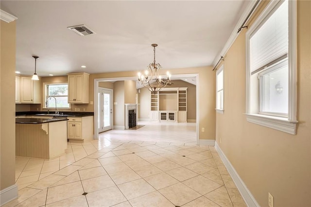 6219 Perlita Dr, New Orleans, LA 70122 - kitchen with light tile patterned floors, dark countertops, recessed lighting, a chandelier, and open floor plan