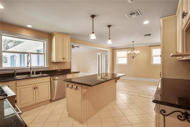 6219 Perlita Dr, New Orleans, LA 70122 - kitchen with stainless steel dishwasher, cream cabinetry, a sink, a center island, and pendant lighting