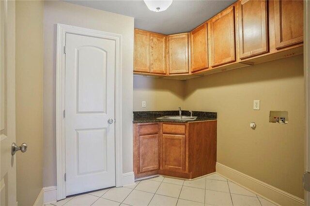 6219 Perlita Dr, New Orleans, LA 70122 - washroom featuring cabinet space, hookup for a washing machine, light tile patterned floors, and baseboards