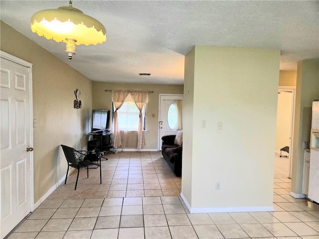126 Boardwalk St, La Place, LA 70068 - dining area featuring light tile patterned floors, a textured ceiling, and baseboards