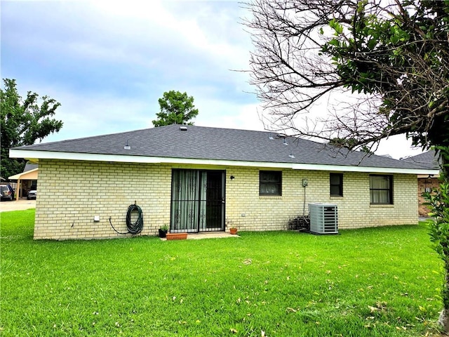 126 Boardwalk St, La Place, LA 70068 - rear view of property with brick siding, central air condition unit, and a yard