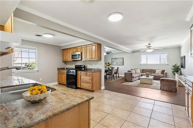 4804 Antonini Dr, Metairie, LA 70006 - kitchen featuring appliances with stainless steel finishes, ceiling fan, a sink, light tile patterned flooring, and baseboards