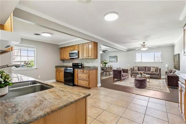 4804 Antonini Dr, Metairie, LA 70006 - kitchen featuring appliances with stainless steel finishes, a sink, ceiling fan, light tile patterned flooring, and open floor plan