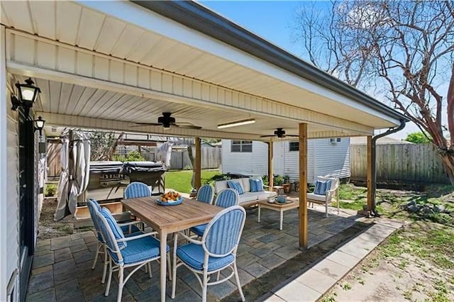 4804 Antonini Dr, Metairie, LA 70006 - fenced backyard featuring ceiling fan, a patio area, a hot tub, outdoor dining space, and a detached carport