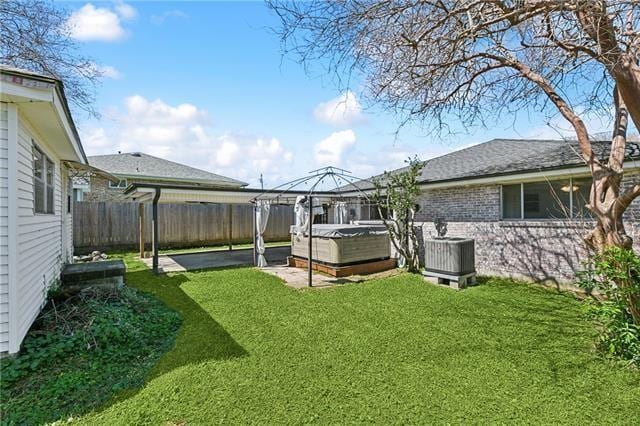 4804 Antonini Dr, Metairie, LA 70006 - view of yard with a hot tub, cooling unit, a gazebo, and a patio