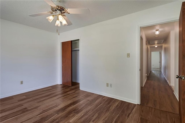1569 Maplewood Dr, Slidell, LA 70458 - unfurnished bedroom featuring attic access, dark wood-style flooring, a textured ceiling, a closet, and baseboards