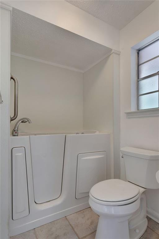 1569 Maplewood Dr, Slidell, LA 70458 - bathroom featuring a textured ceiling, toilet, and tile patterned flooring