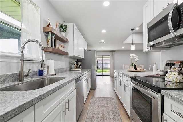 4320 Harvard Ave, Metairie, LA 70006 - kitchen featuring stainless steel appliances, a sink, open shelves, recessed lighting, and light wood-style floors