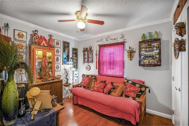 11 Richelle St, Waggaman, LA 70094 - living room featuring a ceiling fan, wood finished floors, ornamental molding, a textured ceiling, and baseboards