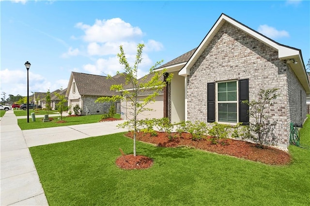 39651 Fairhope Dr, Ponchatoula, LA 70454 - view of front of house featuring concrete driveway, a front lawn, and a garage