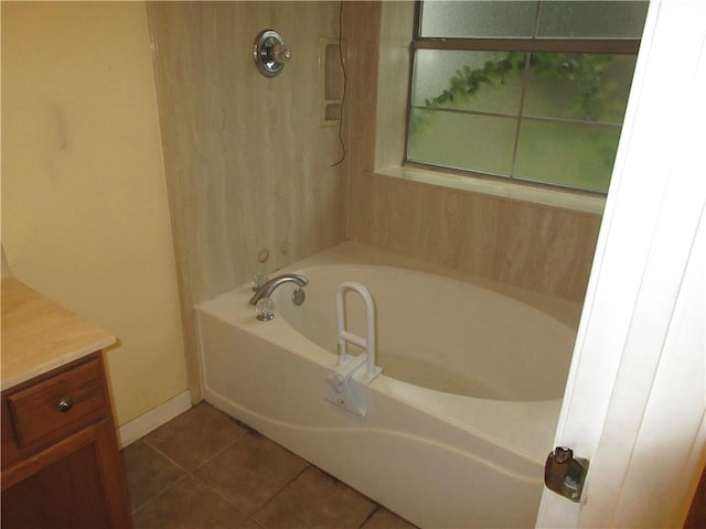 2 Tuscany Dr, La Place, LA 70068 - bathroom featuring a garden tub, tile patterned floors, vanity, and baseboards