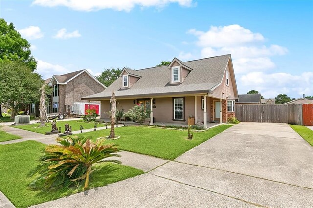 3405 Moss Ln, Violet, LA 70092 - view of front of home featuring concrete driveway, central AC, a gate, covered porch, and brick siding