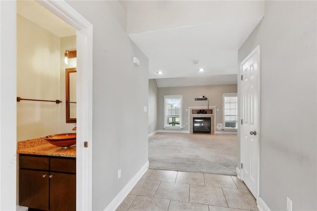 3405 Moss Ln, Violet, LA 70092 - hall featuring a sink, light carpet, light tile patterned flooring, baseboards, and recessed lighting