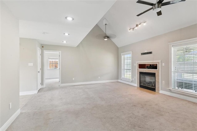 3405 Moss Ln, Violet, LA 70092 - unfurnished living room with ceiling fan, light colored carpet, lofted ceiling, baseboards, and a glass covered fireplace