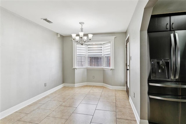 3405 Moss Ln, Violet, LA 70092 - unfurnished dining area with a chandelier, light tile patterned floors, and baseboards