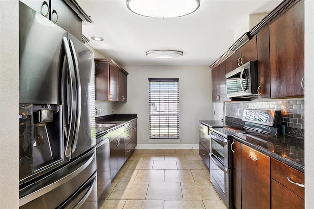 3405 Moss Ln, Violet, LA 70092 - kitchen with appliances with stainless steel finishes, baseboards, decorative backsplash, a sink, and dark brown cabinets
