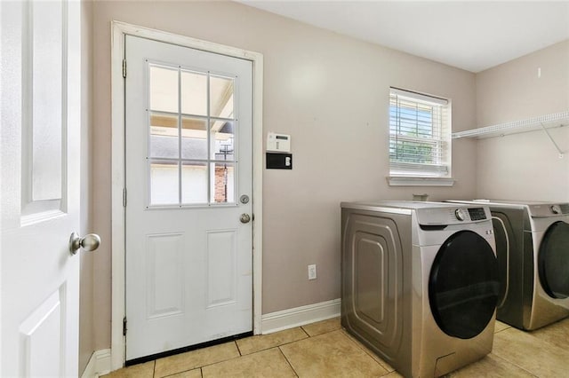 3405 Moss Ln, Violet, LA 70092 - laundry room featuring separate washer and dryer, light tile patterned floors, and baseboards