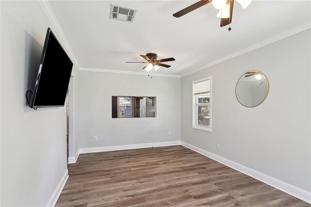 2409 Corinne Dr, Chalmette, LA 70043 - spare room with a ceiling fan, wood finished floors, ornamental molding, and baseboards